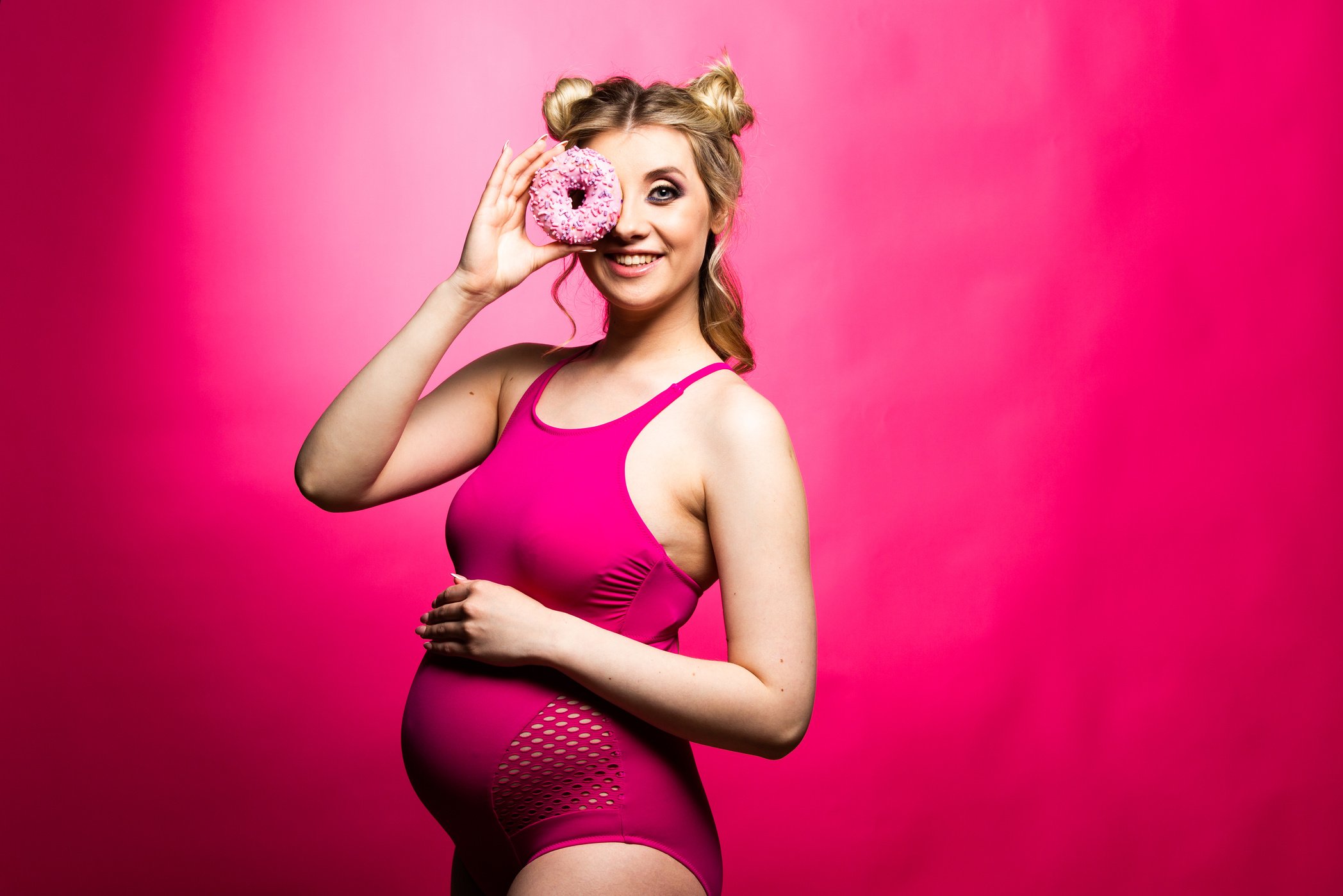 Pregnant eats a donut